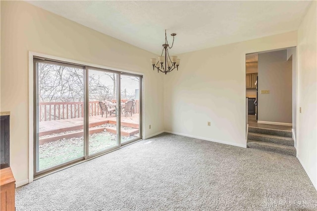 carpeted empty room with stairway, baseboards, and a notable chandelier