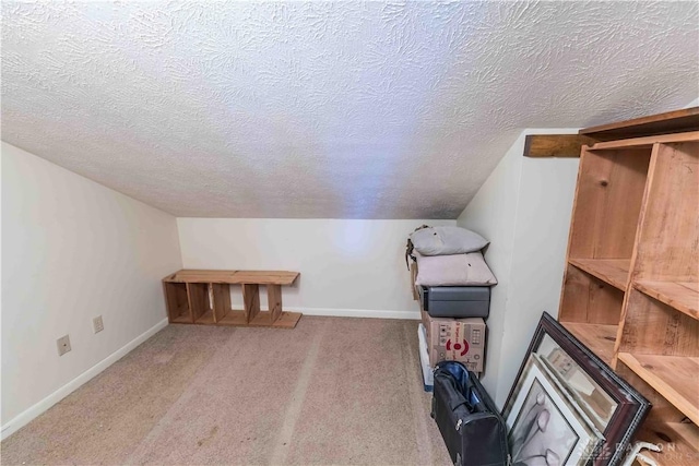 bonus room featuring carpet floors, baseboards, vaulted ceiling, and a textured ceiling