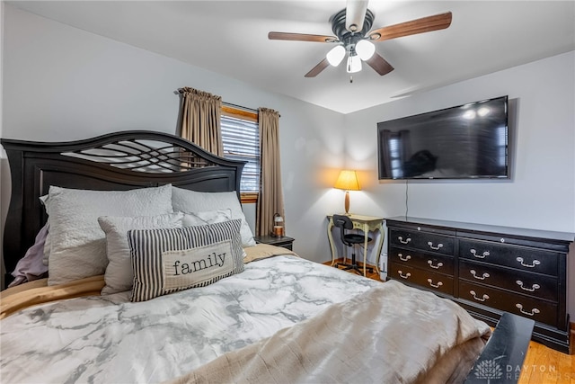 bedroom featuring a ceiling fan and wood finished floors