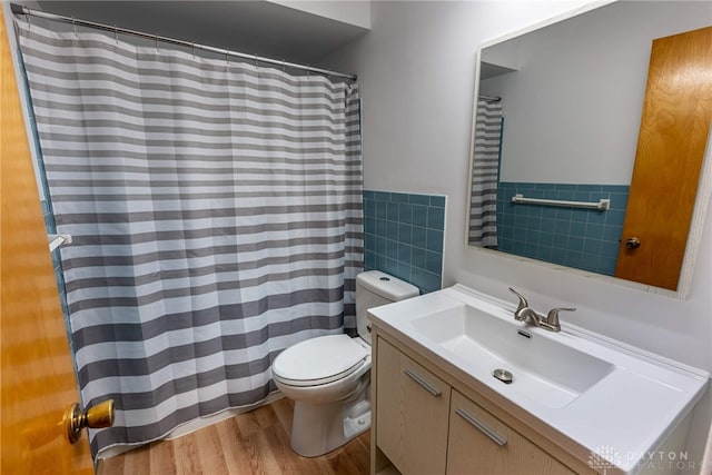 full bath featuring tile walls, toilet, vanity, wood finished floors, and a shower with curtain