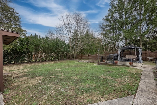 view of yard with a fenced backyard and a gazebo