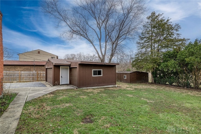 exterior space featuring a fenced backyard, a front yard, and an outbuilding