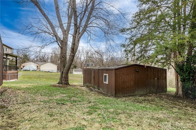 view of yard featuring fence and an outdoor structure