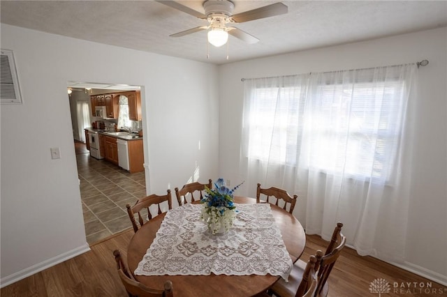 dining space featuring ceiling fan and wood finished floors