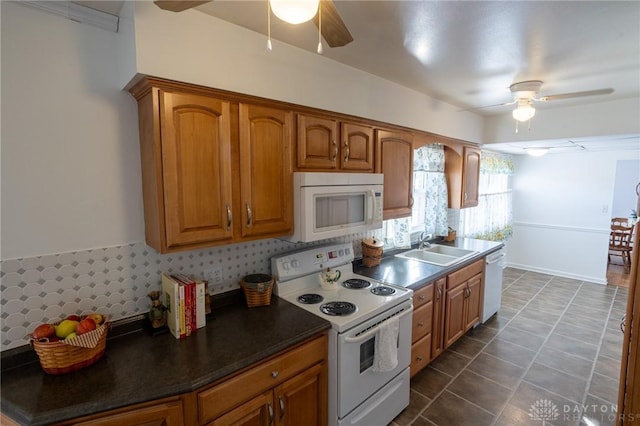 kitchen featuring ceiling fan, white appliances, and brown cabinets