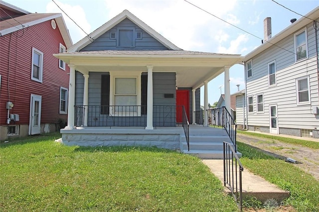 view of front of home with a porch and a front yard