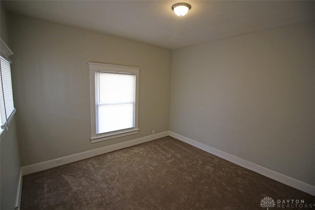 spare room with carpet floors and baseboards