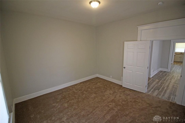 carpeted spare room with baseboards