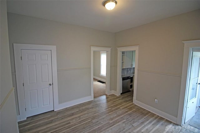 empty room featuring baseboards and wood finished floors