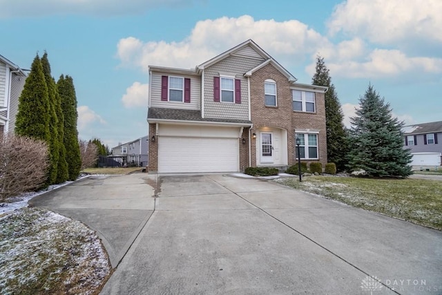 traditional-style home featuring driveway, an attached garage, and brick siding