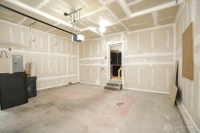 garage featuring electric panel and a garage door opener