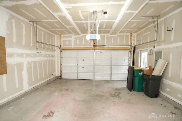 garage with baseboards, electric panel, and a garage door opener