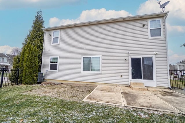 rear view of property with a yard, a patio area, fence, and central AC unit