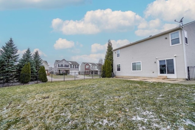 back of property featuring a patio, a lawn, and fence