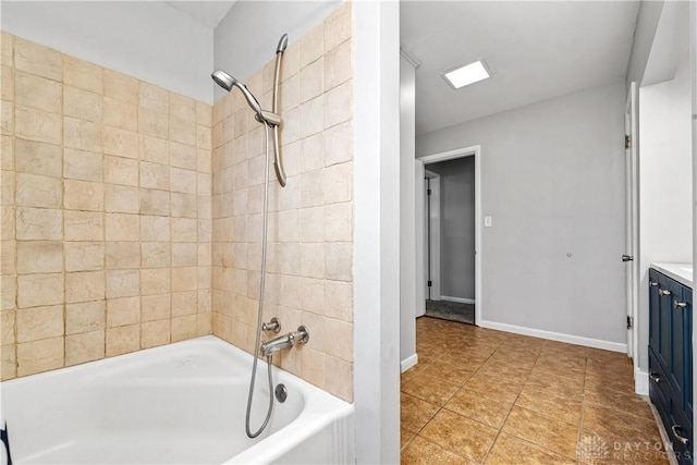 bathroom featuring shower / bathing tub combination, tile patterned floors, vanity, and baseboards