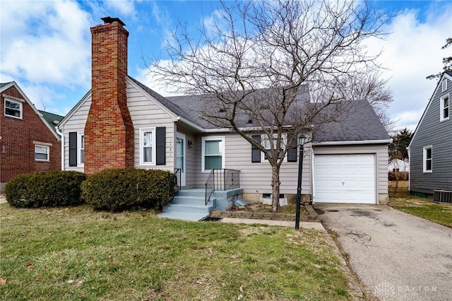 view of front of home featuring a garage, driveway, a chimney, and a front yard