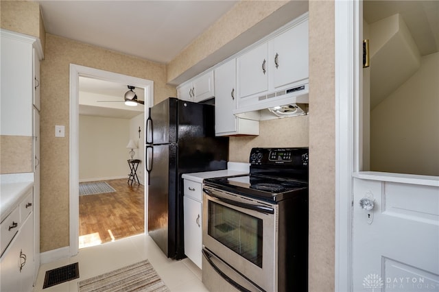 kitchen featuring under cabinet range hood, stainless steel range with electric stovetop, visible vents, and light countertops