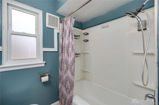 bathroom featuring visible vents and shower / tub combo with curtain