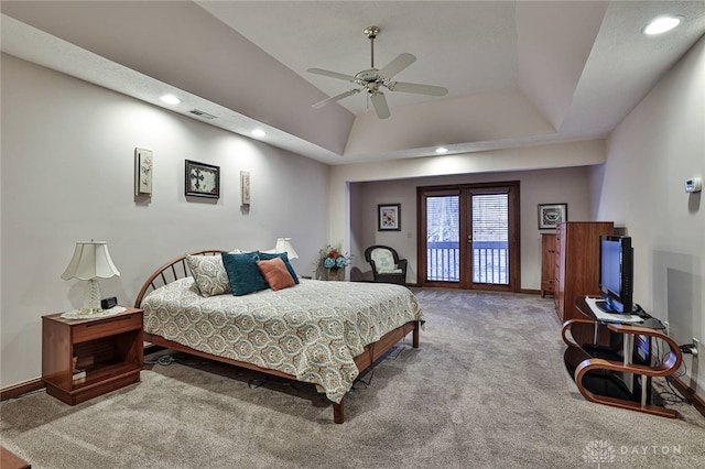 bedroom with visible vents, baseboards, a raised ceiling, access to exterior, and carpet floors