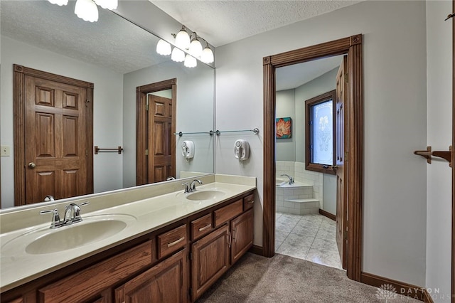 bathroom featuring a garden tub, a sink, a textured ceiling, and double vanity