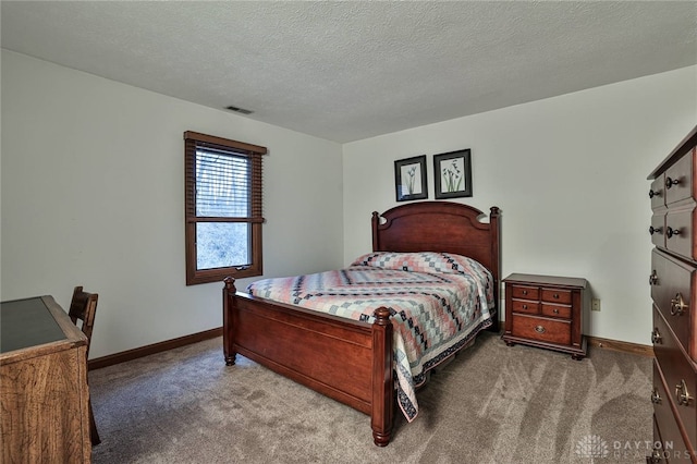 carpeted bedroom featuring visible vents, baseboards, and a textured ceiling