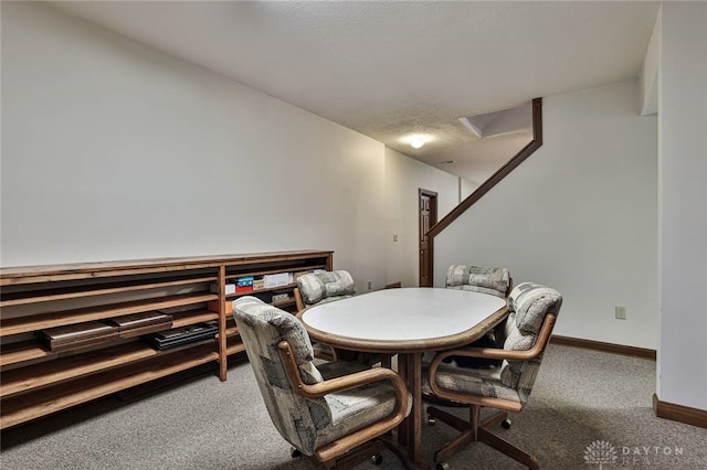 dining room with attic access, baseboards, and carpet flooring