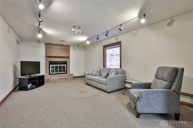 carpeted living room featuring baseboards, a fireplace, visible vents, and a textured ceiling