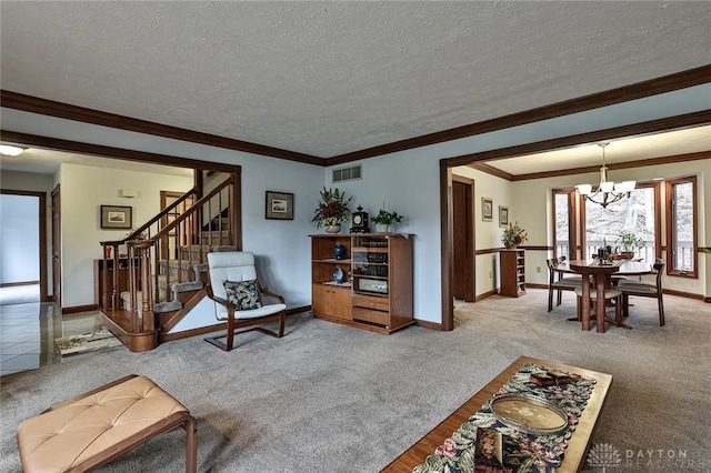 carpeted living room featuring stairs, visible vents, a chandelier, and a textured ceiling