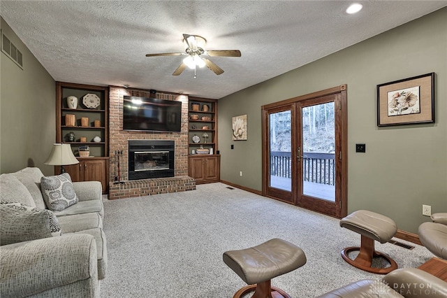 carpeted living room with a textured ceiling, a fireplace, built in features, and baseboards