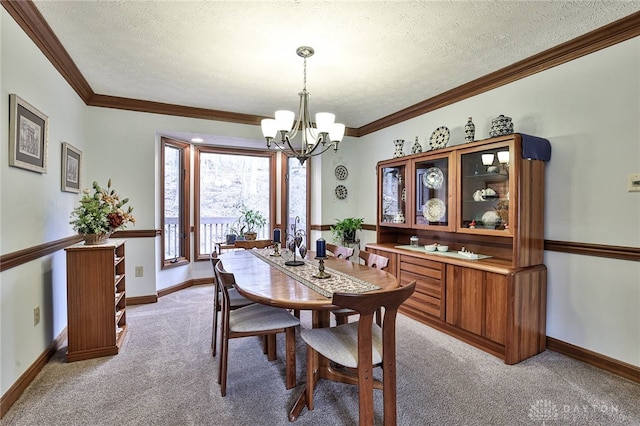 dining space with a chandelier, light carpet, crown molding, and a textured ceiling