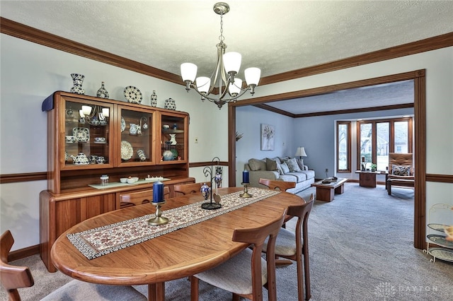 dining space with carpet floors, crown molding, and a textured ceiling