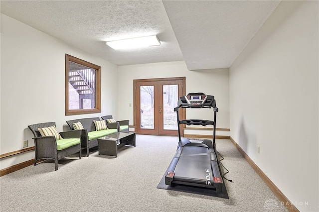 exercise area featuring french doors, carpet flooring, a textured ceiling, and baseboards