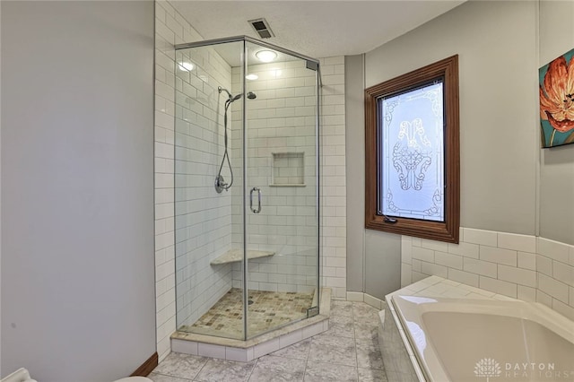 full bath featuring a stall shower, visible vents, and a garden tub