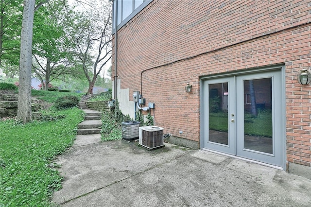 439 Claxton Glen Ct, Dayton, OH 45429 - view of side of home with french doors, brick siding, a patio area, and central AC