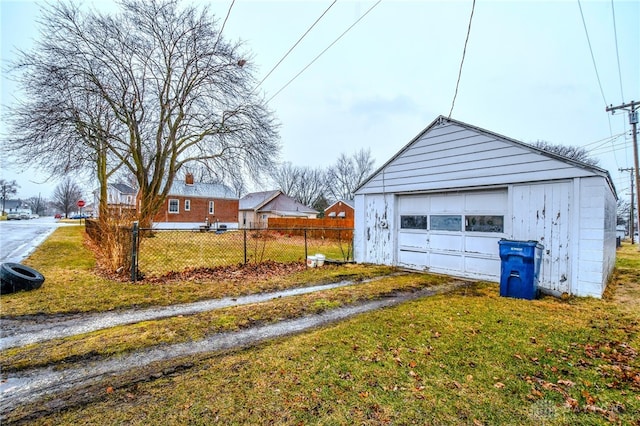 detached garage with aphalt driveway and fence