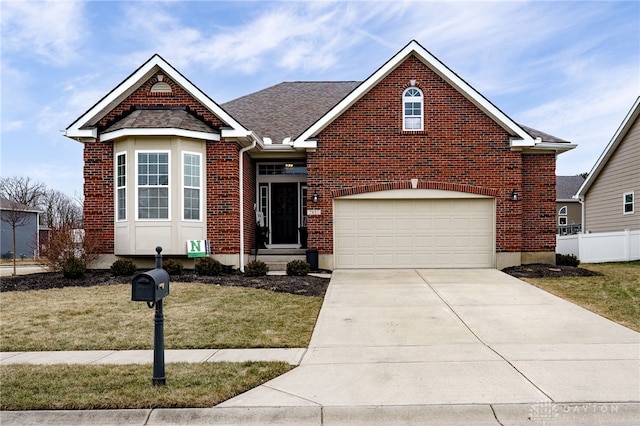 view of front of home featuring driveway, brick siding, and a front lawn