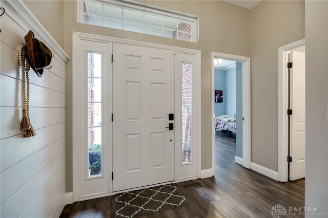 entrance foyer featuring dark wood-style flooring, visible vents, and baseboards