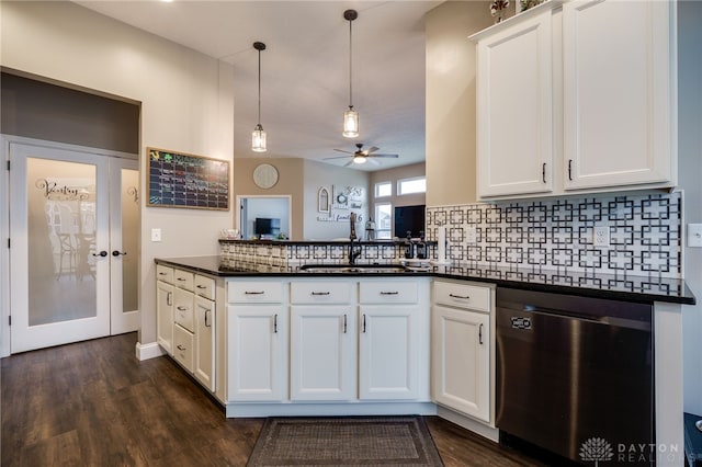 kitchen with decorative backsplash, dishwasher, dark countertops, pendant lighting, and a sink