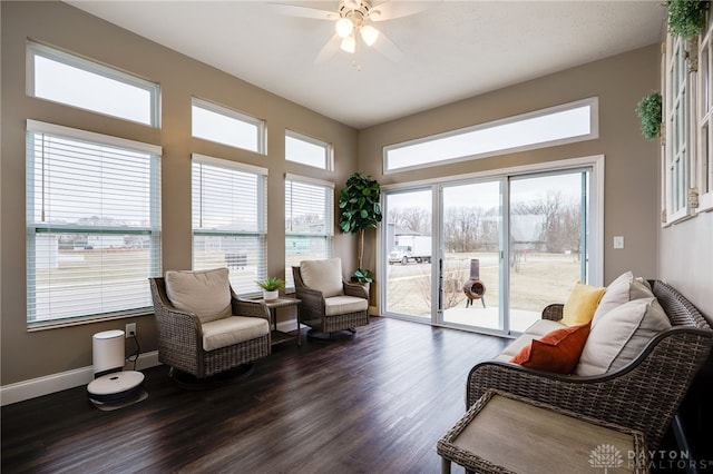 sitting room featuring dark wood-style floors, ceiling fan, and baseboards