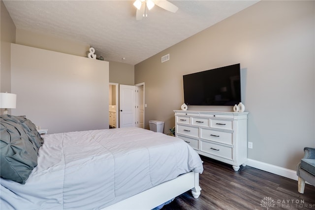 bedroom featuring dark wood-style flooring, visible vents, a ceiling fan, a textured ceiling, and baseboards