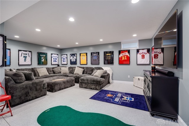 carpeted living area featuring baseboards and recessed lighting