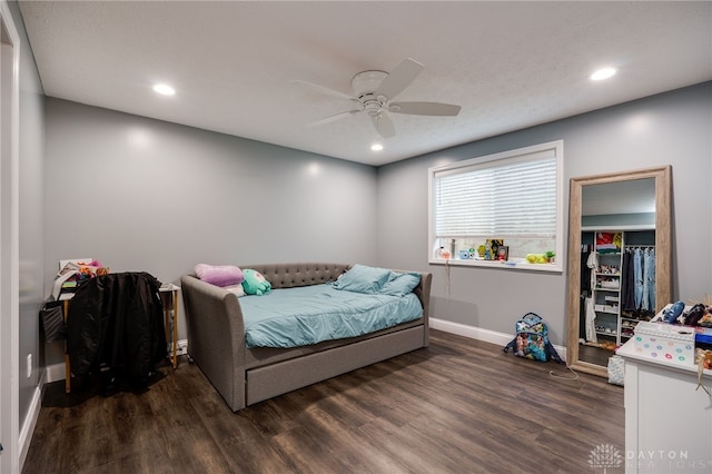 bedroom featuring dark wood-type flooring, recessed lighting, a ceiling fan, and baseboards