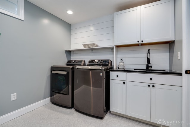 laundry area with cabinet space, baseboards, washer and dryer, a sink, and recessed lighting