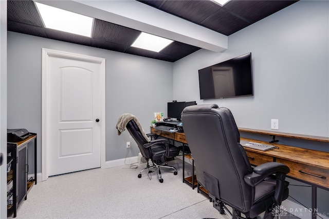 carpeted home office featuring baseboards