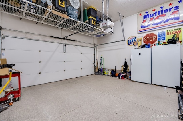 garage featuring a garage door opener and freestanding refrigerator