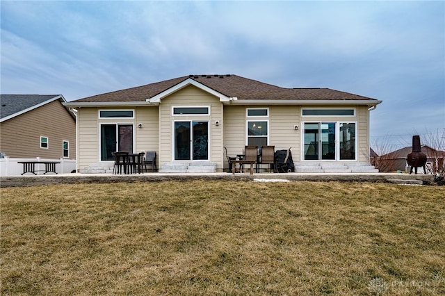 back of property featuring a yard and a patio area