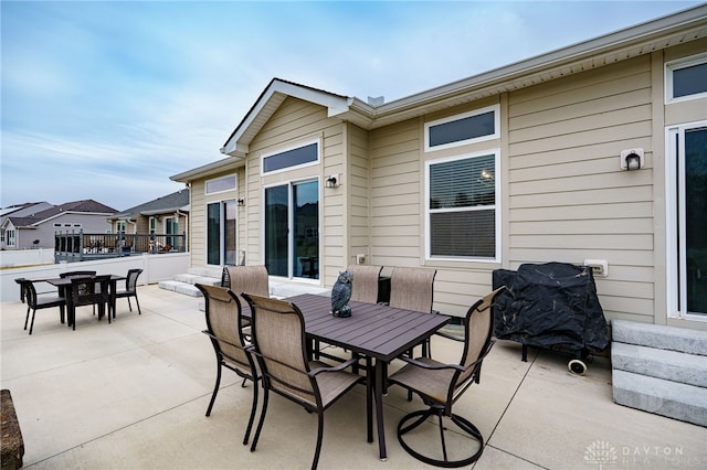 view of patio with outdoor dining area and area for grilling