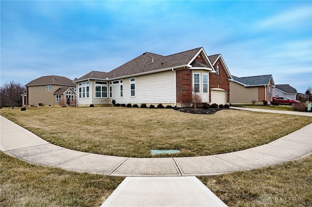 view of front facade with brick siding and a front lawn