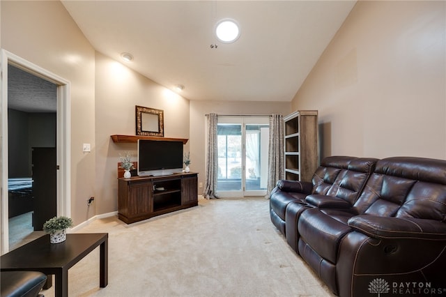 living area featuring light carpet, baseboards, and lofted ceiling