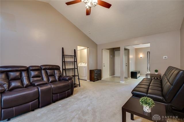 living room featuring ceiling fan, high vaulted ceiling, light colored carpet, baseboards, and washer / dryer